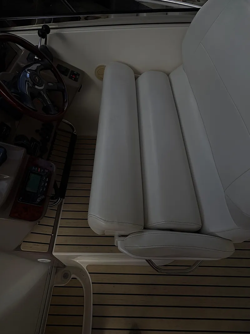 Slide: The Image of 2003 Regal 4260 Express Cruiser interior with white seating and wooden flooring. - 13