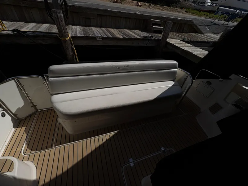 Slide: The Image of 2003 Regal 4260 Express Cruiser interior with white seating and wooden deck. - 16
