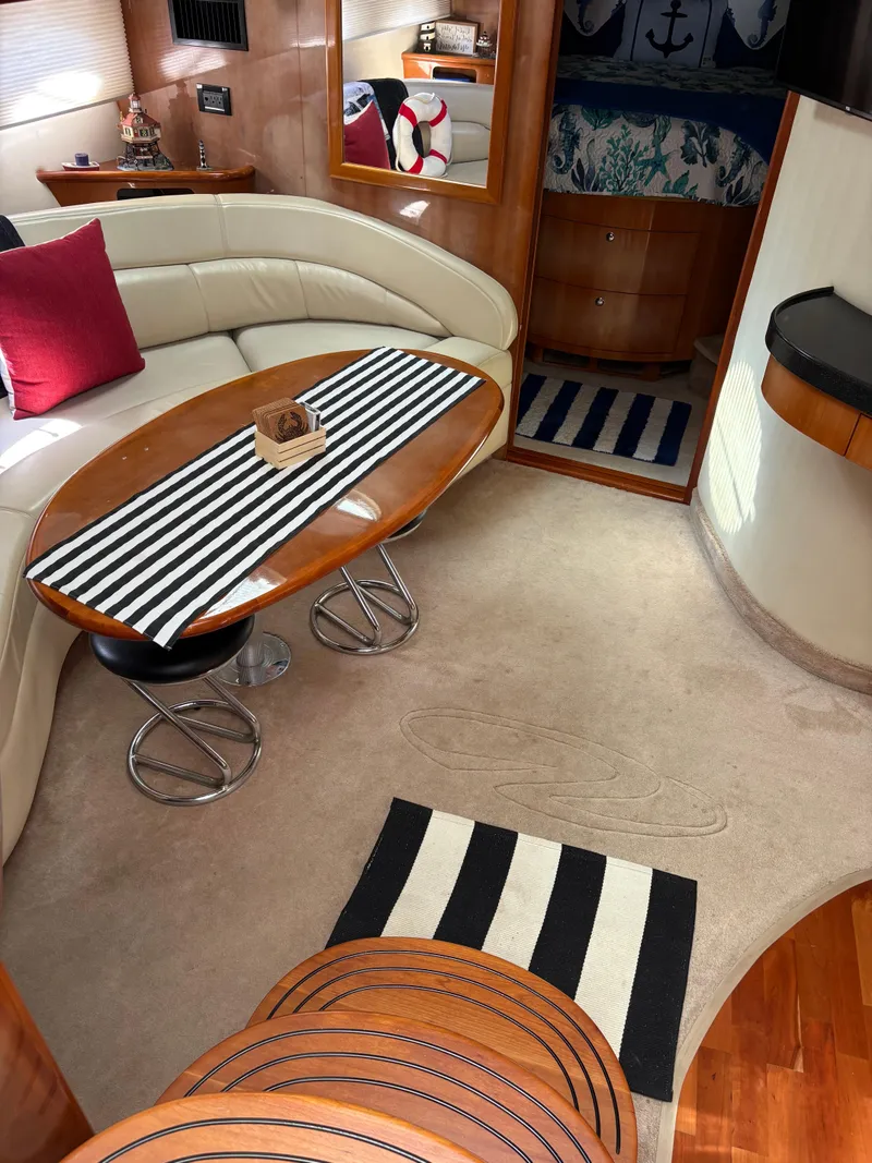 Slide: The Image of 2003 Regal 4260 Express Cruiser interior with striped decor and cozy seating area. - 21