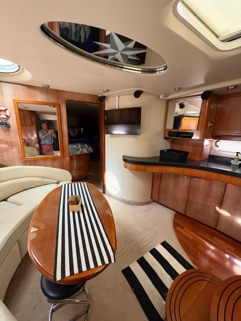 Slide: The Image of Luxurious interior of 2003 Regal 4260 Express Cruiser with modern amenities and elegant wood finishes. - 26