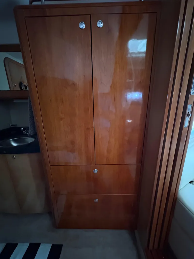 Slide: The Image of Wooden cabinet inside 2003 Regal 4260 Express Cruiser yacht interior. - 27