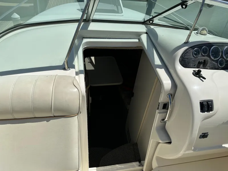 Slide: The Image of 1998 Sea Ray 240 Sundancer boat interior with cockpit view and cabin entrance. - 15