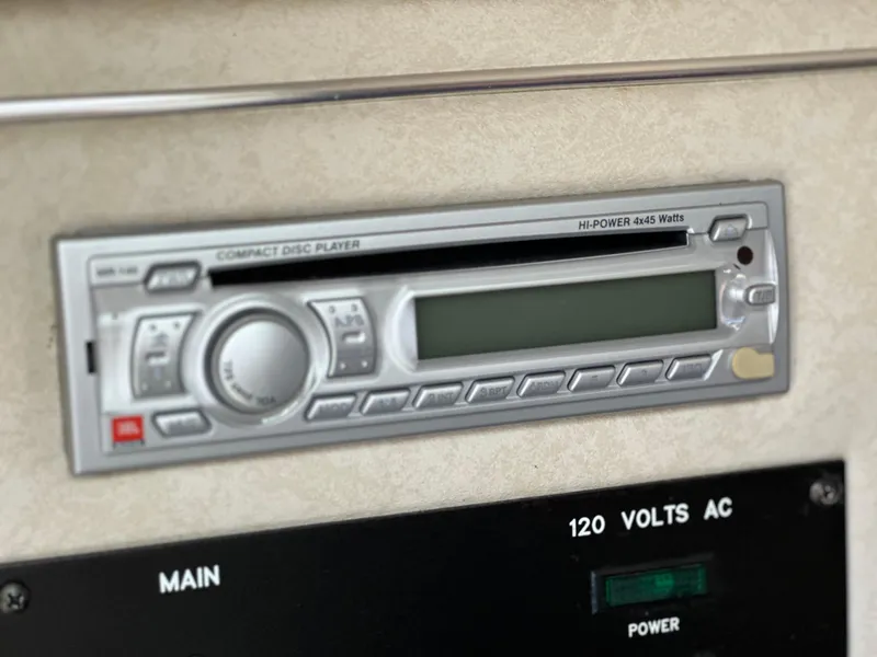 Slide: The Image of 1998 Sea Ray 240 Sundancer stereo system and power panel, featuring a compact disc player. - 27