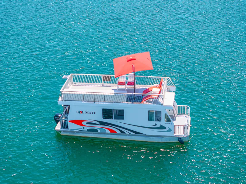 Slide: The Image of Houseboat on clear water, Twin Anchors 3010, 2016 model, with red canopy and modern design. - 12