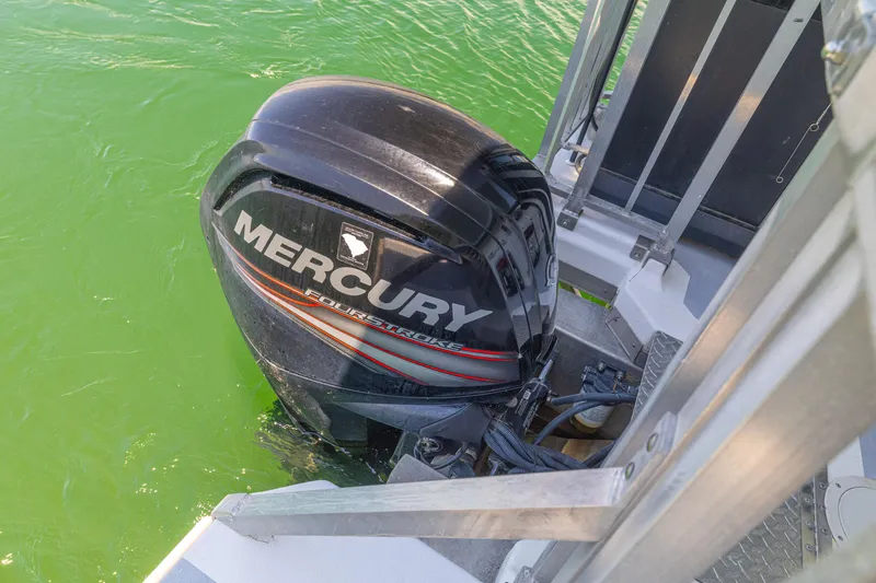 Slide: The Image of Mercury outboard motor on 2016 Twin Anchors 3010 boat in green water. - 19