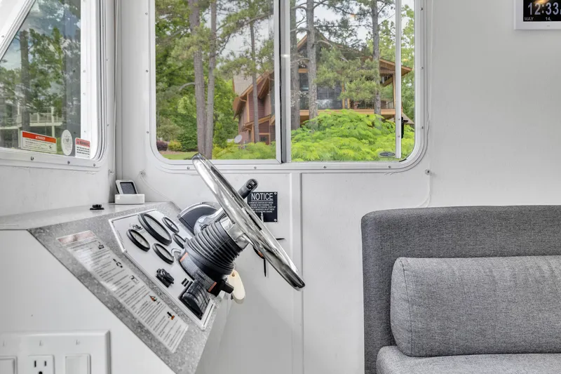 Slide: The Image of Interior of 2016 Twin Anchors 3010 houseboat with steering wheel and control panel. - 38