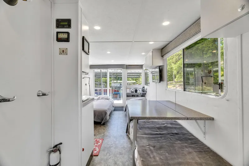 Slide: The Image of Interior of 2016 Twin Anchors 3010 houseboat with dining area and large windows. - 44