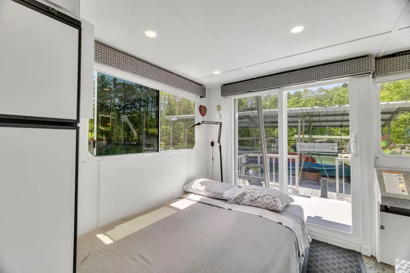 Slide: The Image of Cozy bedroom in 2016 Twin Anchors 3010 houseboat with large windows and natural light. - 46