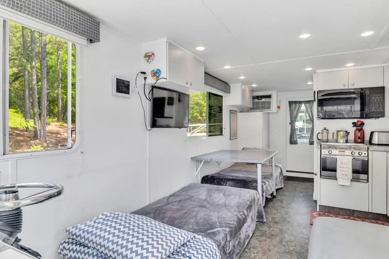 Slide: The Image of Interior of 2016 Twin Anchors 3010 houseboat with modern kitchen and cozy sleeping area. - 47