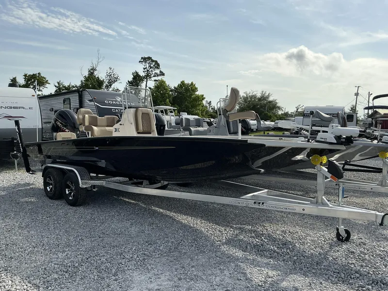Slide: The Image of 2025 Xpress Hyper-Lift Series H22B boat on trailer, parked outdoors. - 1