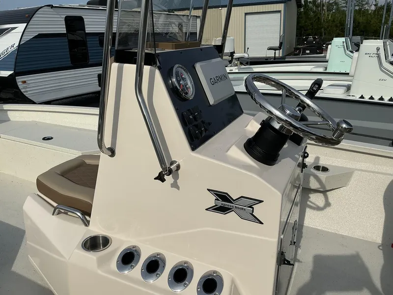 Slide: The Image of 2025 Xpress Hyper-Lift Series H22B boat console with steering wheel and Garmin display. - 10