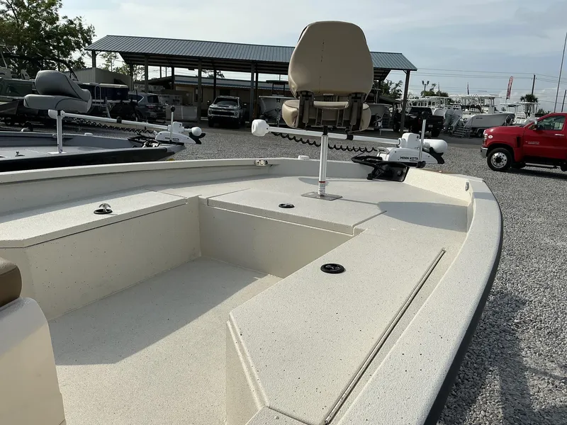 Slide: The Image of 2025 Xpress Hyper-Lift Series H22B boat with seating and trolling motor in a dealership lot. - 2