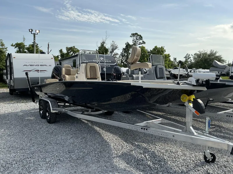 Slide: The Image of 2025 Xpress Hyper-Lift Series H22B boat on trailer, parked in a gravel lot. - 7