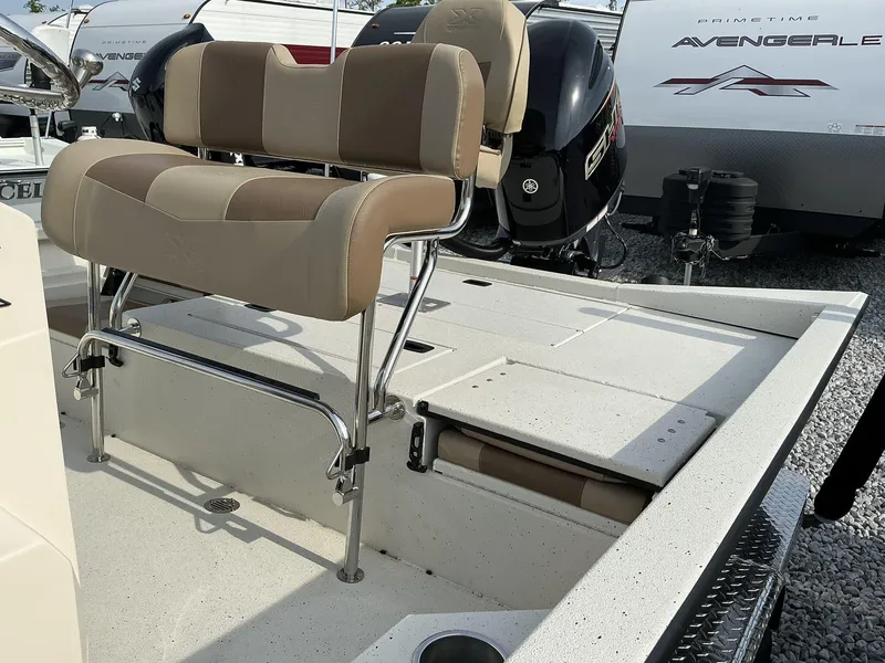 Slide: The Image of 2025 Xpress Hyper-Lift Series H22B boat interior with cushioned seating and storage compartments. - 12