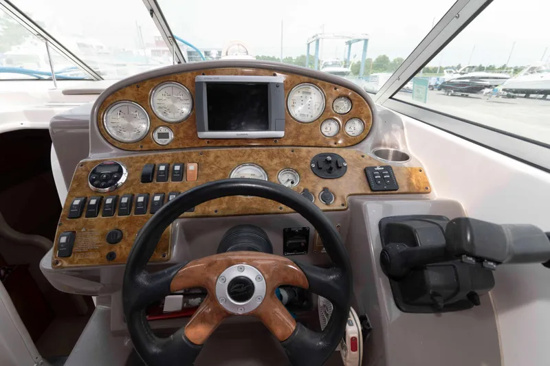 Slide: The Image of 2007 Rinker 300 Express Cruiser dashboard with steering wheel and control panel. - 10