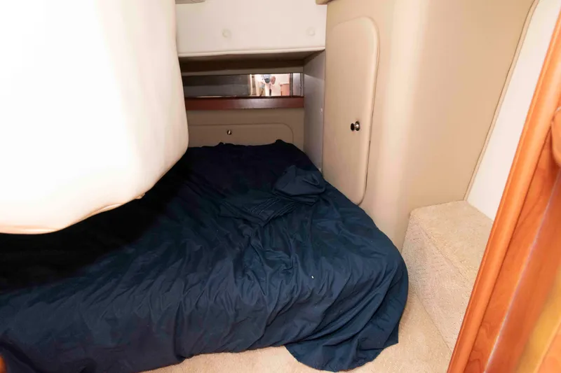 Slide: The Image of 2007 Rinker 300 Express Cruiser cabin with bed and storage area. - 15
