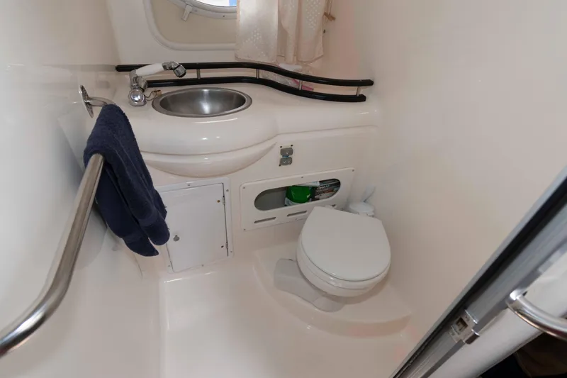 Slide: The Image of 2007 Rinker 300 Express Cruiser bathroom with sink and toilet. - 16