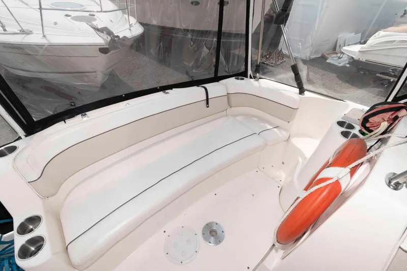 Slide: The Image of 2007 Rinker 300 Express Cruiser interior with white seating and life preserver. - 4