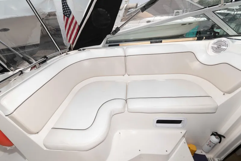 Slide: The Image of 2007 Rinker 300 Express Cruiser interior with white seating and American flag. - 5