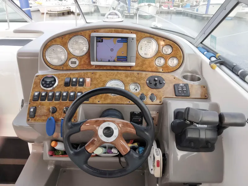 Slide: The Image of 2007 Rinker 300 Express Cruiser dashboard with GPS, gauges, and controls. - 8