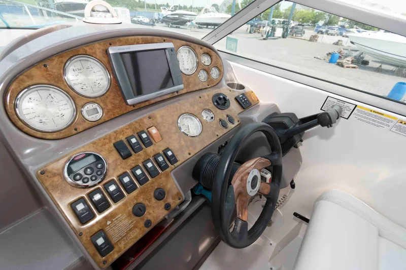 Slide: The Image of 2007 Rinker 300 Express Cruiser dashboard with gauges, controls, and steering wheel. - 9