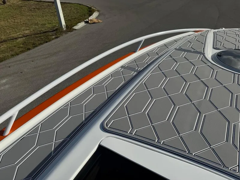 Slide: The Image of 2015 Deep Impact 399 Cabin boat with geometric deck design and sleek railing. - 24