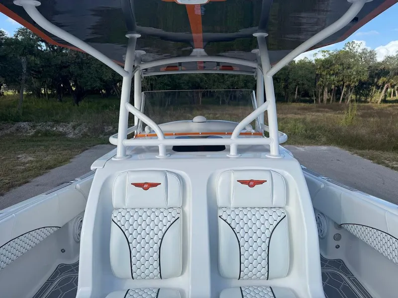 Slide: The Image of 2015 Deep Impact 399 Cabin boat interior with white seating and canopy. - 31