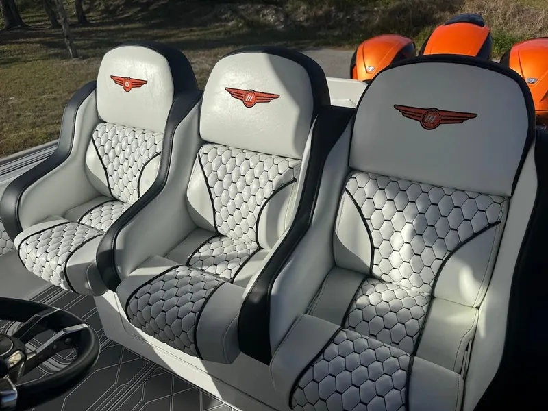 Slide: The Image of Luxurious seating in a 2015 Deep Impact 399 Cabin boat with stylish upholstery and logo. - 33