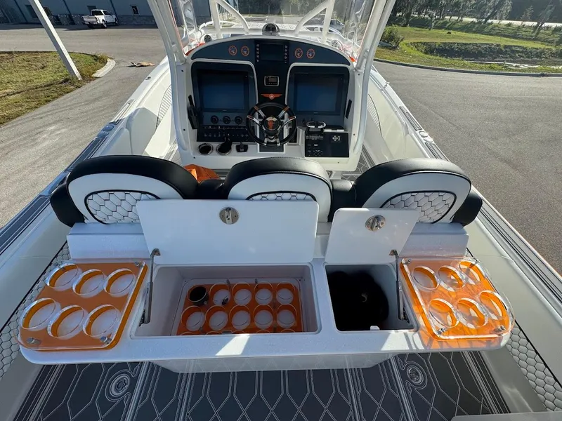 Slide: The Image of 2015 Deep Impact 399 Cabin boat interior with helm, seating, and storage compartments. - 34