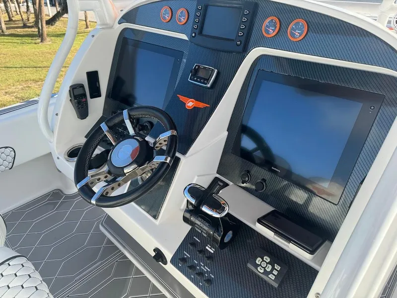 Slide: The Image of Control panel of a 2015 Deep Impact 399 Cabin boat with modern navigation screens. - 35