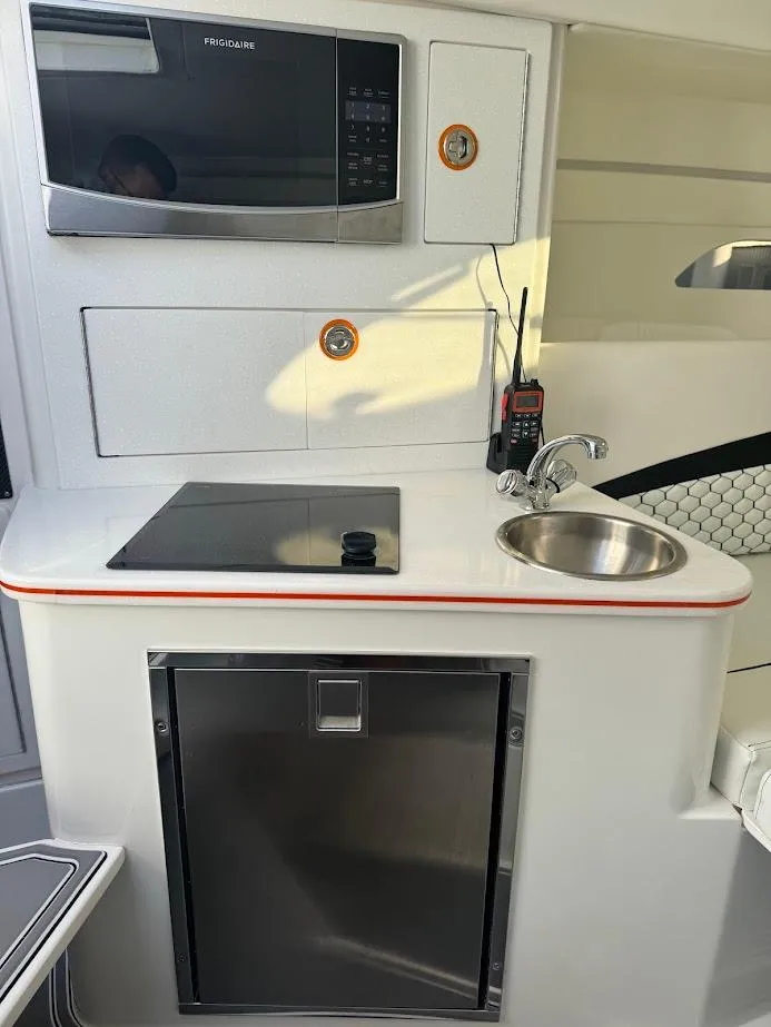 Slide: The Image of 2015 Deep Impact 399 Cabin interior with kitchenette, microwave, sink, and storage. - 40