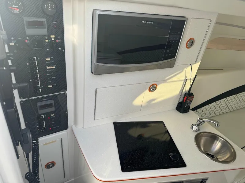 Slide: The Image of Interior of a 2015 Deep Impact 399 Cabin with kitchenette and control panel. - 44