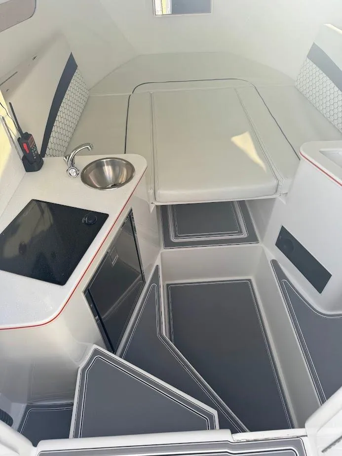 Slide: The Image of 2015 Deep Impact 399 Cabin interior with kitchenette, sink, and seating area. - 45