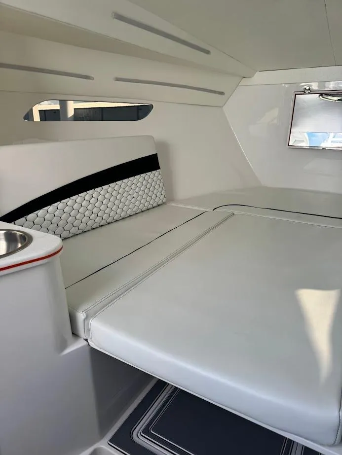 Slide: The Image of 2015 Deep Impact 399 Cabin interior with sleek white seating and modern design. - 47