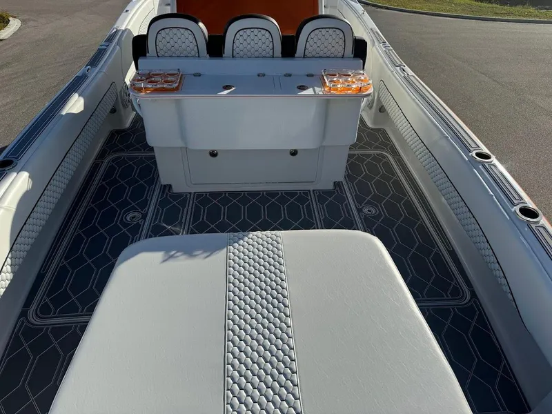 Slide: The Image of 2015 Deep Impact 399 Cabin boat interior with stylish seating and textured flooring. - 48