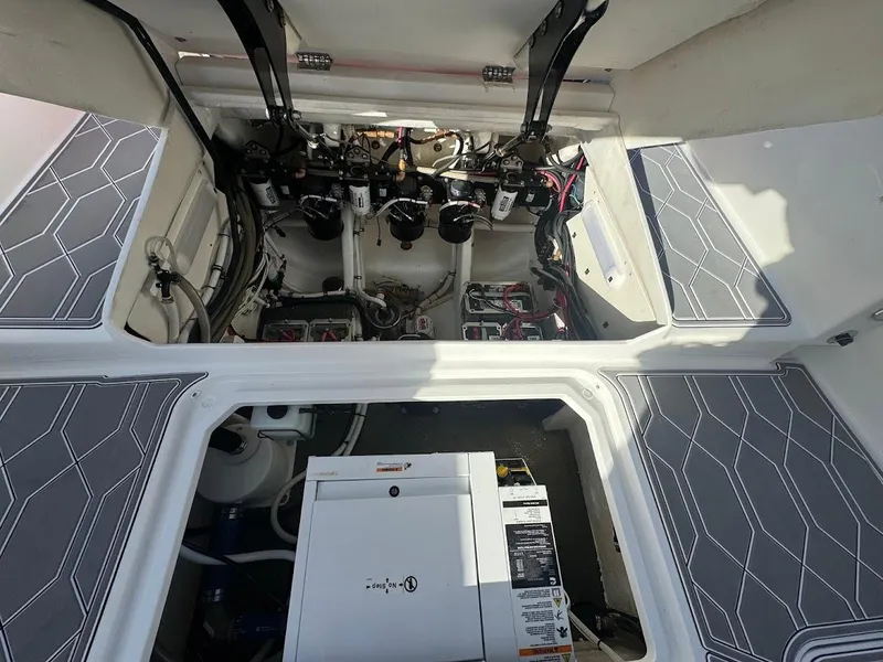 Slide: The Image of Engine compartment of a 2015 Deep Impact 399 Cabin boat, showcasing mechanical components. - 49