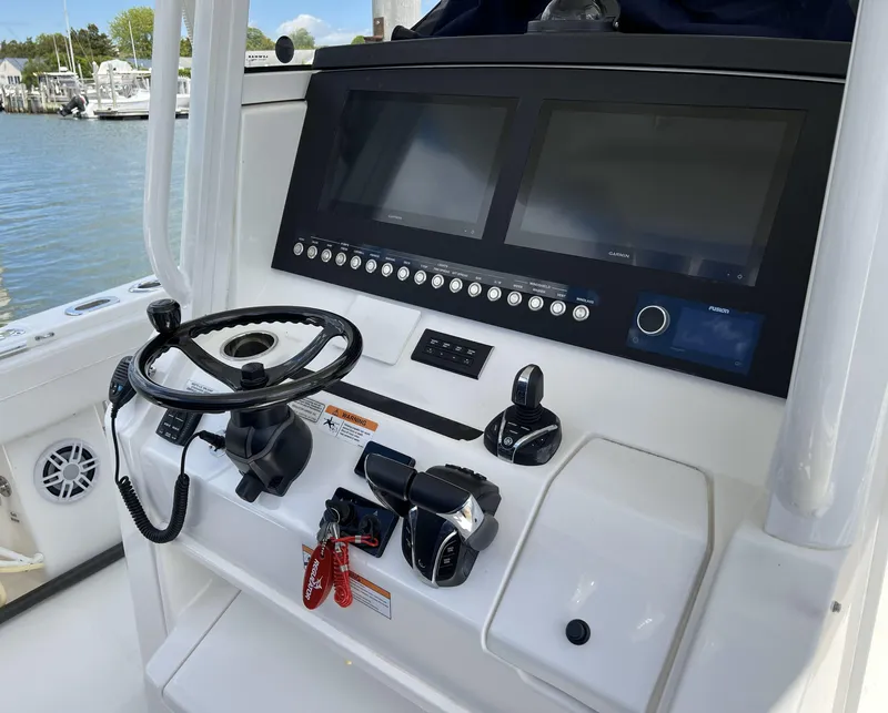Slide: The Image of 2022 Regulator 31 boat dashboard with dual screens and steering wheel. - 3