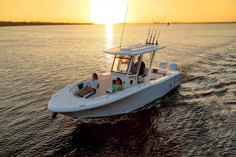 Slide: The Image of 2023 Robalo R270 boat cruising at sunset with passengers on board. - 7