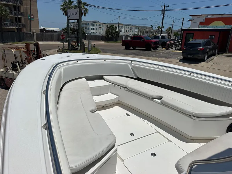 Slide: The Image of 2008 Fountain Center Console boat with spacious seating, parked near urban area. - 10