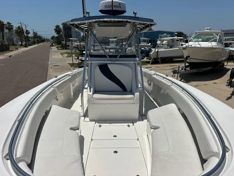 Slide: The Image of 2008 Fountain Center Console boat with white seating and Garmin equipment, docked near other boats. - 12