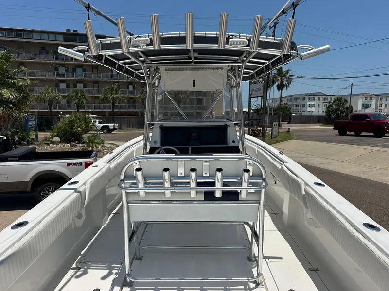 Slide: The Image of 2008 Fountain Center Console boat with T-top and rod holders, parked near buildings. - 5