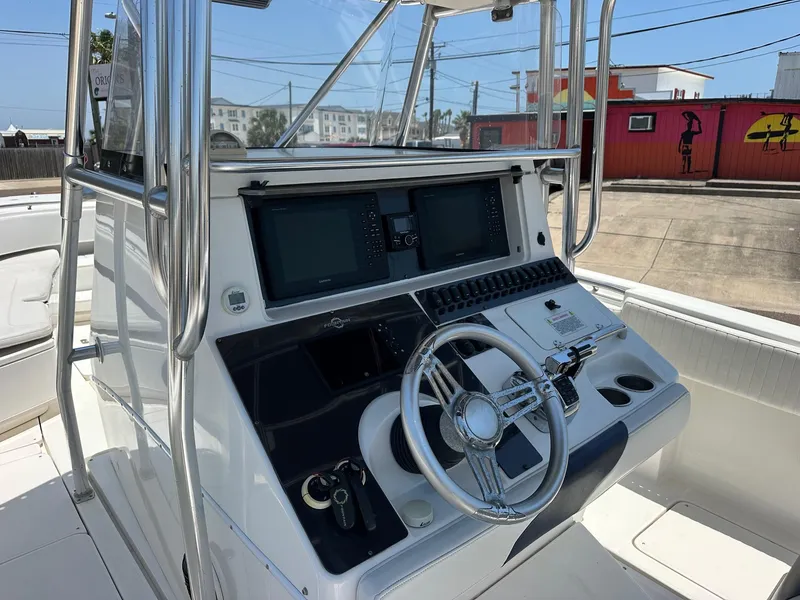 Slide: The Image of 2008 Fountain Center Console boat dashboard with steering wheel and navigation screens. - 7