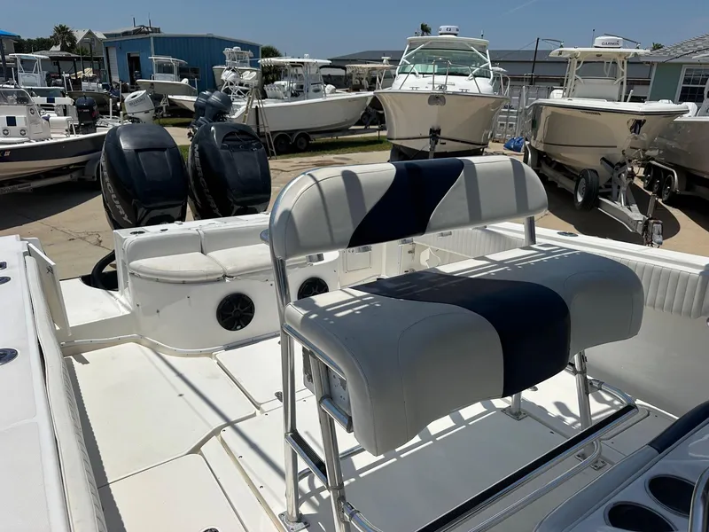 Slide: The Image of 2008 Fountain Center Console boat with dual engines and cushioned seating in a marina. - 8