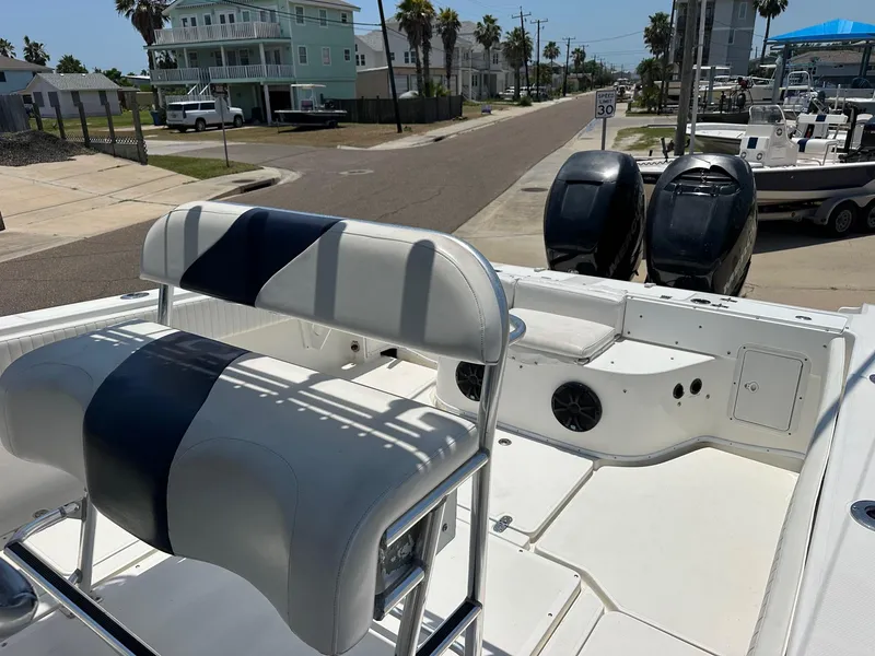 Slide: The Image of 2008 Fountain Center Console boat with dual engines, docked near coastal homes. - 9