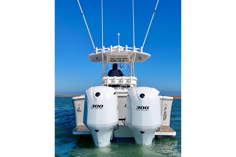 Slide: The Image of 2016 Regulator 28 Forward Seating boat with twin 300 horsepower engines on water. - 3