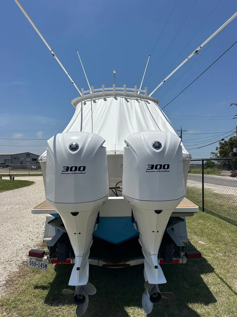 Slide: The Image of 2016 Regulator center console boat with twin 300 horsepower engines, parked on a trailer. - 5