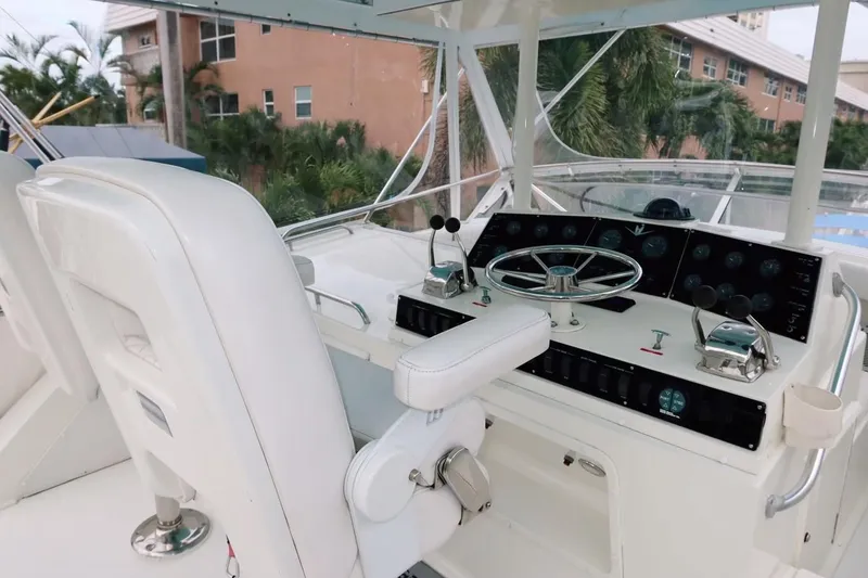 Slide: The Image of 1983 Bertram 46 Convertible yacht helm with steering wheel and controls. - 13