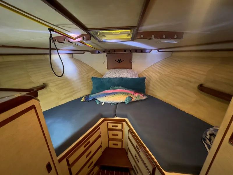Slide: The Image of 1983 Bertram 46 Convertible cabin with cozy bed and fish-themed decor. - 18