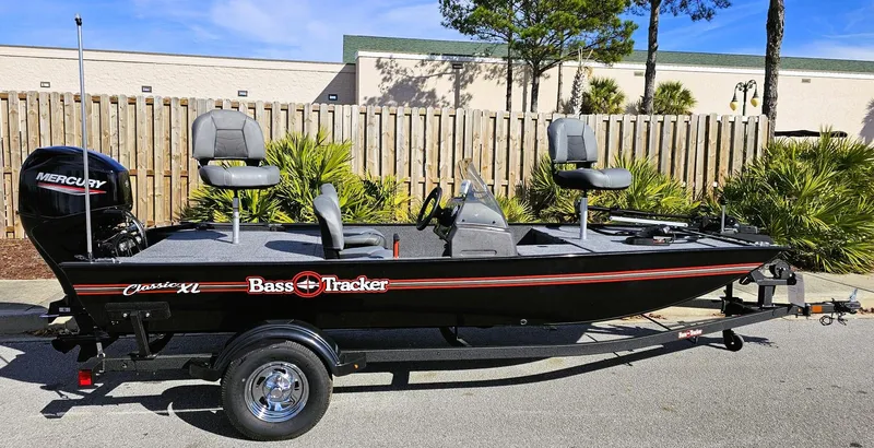 Slide: The Image of 2025 Tracker Bass Tracker Classic XL boat on trailer, parked outdoors. - 2