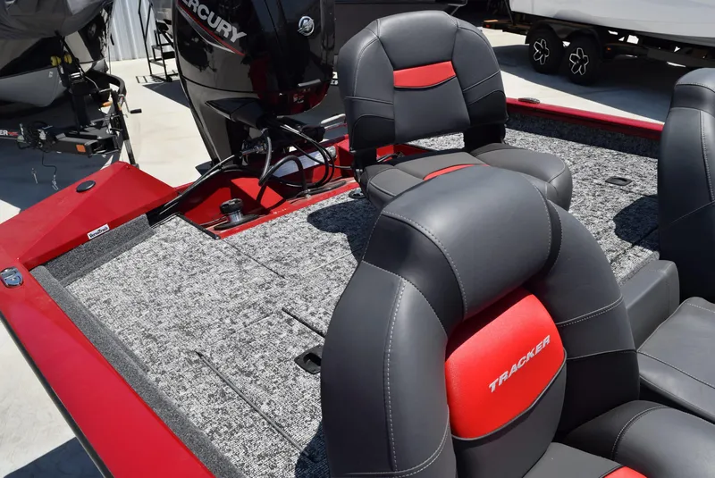 Slide: The Image of 2025 Tracker Pro Team 175 boat interior with red and black seating, Mercury engine visible. - 4